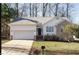 Charming single Gathering home with attached garage, manicured lawn, and a welcoming entrance at 100 W Acres Cres, Cary, NC 27519