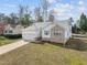 A charming home with a two-car garage, brick accents, and a well-manicured lawn at 100 W Acres Cres, Cary, NC 27519