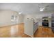 Bright and airy kitchen flows from the living room, featuring white cabinets and a stainless steel refrigerator at 100 W Acres Cres, Cary, NC 27519