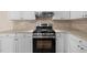 Kitchen featuring modern appliances, wood countertops, and white cabinets at 100 W Acres Cres, Cary, NC 27519