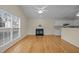 Open concept living room featuring hardwood floors, a fireplace, and a view of the kitchen at 100 W Acres Cres, Cary, NC 27519