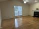 Living room featuring hardwood floors, a fireplace, and a window with natural light at 100 W Acres Cres, Cary, NC 27519