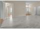 Bright living room featuring newly-laid white vinyl flooring and neutral paint tones at 100 W Acres Cres, Cary, NC 27519