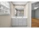 A main bathroom with a double vanity, mirror, and a separate shower and tub at 100 W Acres Cres, Cary, NC 27519