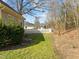 A well-maintained lawn and white picket fence border this charming home's backyard, inviting relaxation at 10040 Ward, Chapel Hill, NC 27517