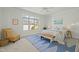 Spacious bedroom with a blue rug, a mustard chair, and natural light at 10040 Ward, Chapel Hill, NC 27517