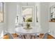 Bright dining nook with large bay windows and a round white dining table at 10040 Ward, Chapel Hill, NC 27517