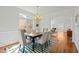 Elegant dining room featuring a large window, decorative chandelier, and seating for six at 10040 Ward, Chapel Hill, NC 27517