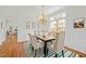 Well-lit dining area with seating for six, stylish rug, and views to the living room at 10040 Ward, Chapel Hill, NC 27517