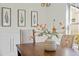Dining room table decorated with floral arrangement and leaf-themed art pieces at 10040 Ward, Chapel Hill, NC 27517