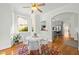 Sunlit dining room featuring hardwood floors, large windows, and modern decor at 10040 Ward, Chapel Hill, NC 27517
