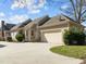 Rear exterior with neutral siding, a two-car garage, and a spacious driveway offers both function and curb appeal at 10040 Ward, Chapel Hill, NC 27517