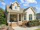 Charming home with well-manicured landscaping, covered porch, and classic architectural details at 10040 Ward, Chapel Hill, NC 27517