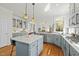 Open concept kitchen features stainless steel appliances, a central island, and ample counter space at 10040 Ward, Chapel Hill, NC 27517