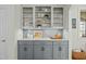 Gray cabinets and glass front upper cabinets offer an elevated design in this lovely kitchen at 10040 Ward, Chapel Hill, NC 27517