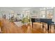 Bright living room with hardwood floors, piano, and views of the manicured outdoor landscape at 10040 Ward, Chapel Hill, NC 27517