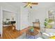 Sunlit living area with hardwood floors, neutral tones, and French doors leading to another room at 10040 Ward, Chapel Hill, NC 27517