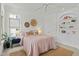 This primary bedroom boasts a ceiling fan, built-in shelving, and woven wall decor at 10040 Ward, Chapel Hill, NC 27517