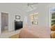 This primary bedroom has a large window, dark dresser, and ensuite bathroom at 10040 Ward, Chapel Hill, NC 27517
