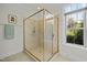Modern bathroom with a glass enclosed shower, tiled walls, and natural light at 10040 Ward, Chapel Hill, NC 27517