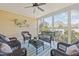 Enclosed sunroom featuring wicker furniture, overhead fan, and multiple windows at 10040 Ward, Chapel Hill, NC 27517