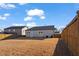 Backyard features a wooden fence, blue sky and lawn at 1008 Sandtrap Way, Durham, NC 27703
