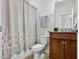 Bathroom featuring a shower with decorative curtain and vanity with granite countertop at 1008 Sandtrap Way, Durham, NC 27703