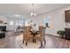 Bright dining area features modern chandelier, wood floors, and neutral paint at 1008 Sandtrap Way, Durham, NC 27703