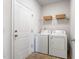 Convenient laundry room includes washer, dryer, and shelving for storage at 1008 Sandtrap Way, Durham, NC 27703