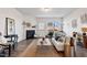 Cozy living room with a fireplace, stylish decor, and natural light from the windows at 1008 Sandtrap Way, Durham, NC 27703
