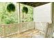 Relaxing outdoor space on the back porch with hanging plants and wooded views at 106 Choptank Ct # B3, Cary, NC 27513