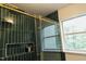 Elegant bathroom shower featuring modern shower head, storage, and emerald tiles at 106 Choptank Ct # B3, Cary, NC 27513