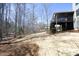 Backyard featuring a large, landscaped yard, direct access to a screened-in porch, and ample wooded space at 106 Rolling Meadows Ln, Chapel Hill, NC 27517