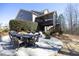 Backyard with outdoor patio set, screened in porch, and beautifully landscaped yard at 106 Rolling Meadows Ln, Chapel Hill, NC 27517