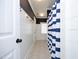 Nautical-themed bathroom with white shiplap walls and a blue and white striped shower curtain at 106 Rolling Meadows Ln, Chapel Hill, NC 27517