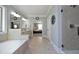 Bright bathroom features a tub, tiled floors, and a view into the main bedroom at 106 Rolling Meadows Ln, Chapel Hill, NC 27517
