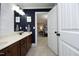 Stylish bathroom with a wood vanity, white countertops, and a view into an adjacent bedroom at 106 Rolling Meadows Ln, Chapel Hill, NC 27517