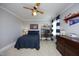 Comfortable bedroom with a ceiling fan, desk, and baseball-themed decor at 106 Rolling Meadows Ln, Chapel Hill, NC 27517