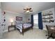 Comfortable bedroom with a plaid-patterned bed, window, side table, and office space at 106 Rolling Meadows Ln, Chapel Hill, NC 27517