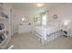 Charming bedroom with a white four-poster bed, dresser, and neutral decor at 106 Rolling Meadows Ln, Chapel Hill, NC 27517