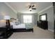 Comfortable bedroom has soft carpet, a ceiling fan, and windows for natural light at 106 Rolling Meadows Ln, Chapel Hill, NC 27517