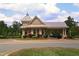 View of the community entrance, featuring a decorative gate, and a well-maintained landscape at 106 Rolling Meadows Ln, Chapel Hill, NC 27517