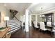 Open-concept dining room featuring hardwood floors, elegant chandelier, and staircase at 106 Rolling Meadows Ln, Chapel Hill, NC 27517