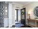 Inviting foyer with dark wood floors, decorative mirrors, and view to the front porch at 106 Rolling Meadows Ln, Chapel Hill, NC 27517