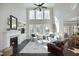 Spacious living room with high ceilings, fireplace, built-ins, and ample natural light at 106 Rolling Meadows Ln, Chapel Hill, NC 27517