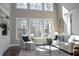 Bright living room featuring a fireplace, large windows and comfortable seating area at 106 Rolling Meadows Ln, Chapel Hill, NC 27517