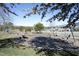 Community playground with swings, play equipment, picnic tables, and a wooden border at 106 Rolling Meadows Ln, Chapel Hill, NC 27517