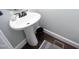 Compact powder room boasts a pedestal sink and stylish accents at 106 Rolling Meadows Ln, Chapel Hill, NC 27517