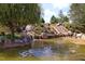 Picturesque tiered water feature flowing into a pond, surrounded by rocks and trees at 106 Rolling Meadows Ln, Chapel Hill, NC 27517