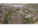 Aerial view of a home in a wooded neighborhood with a lake in the distance at 107 Kingsmill Rd, Cary, NC 27511